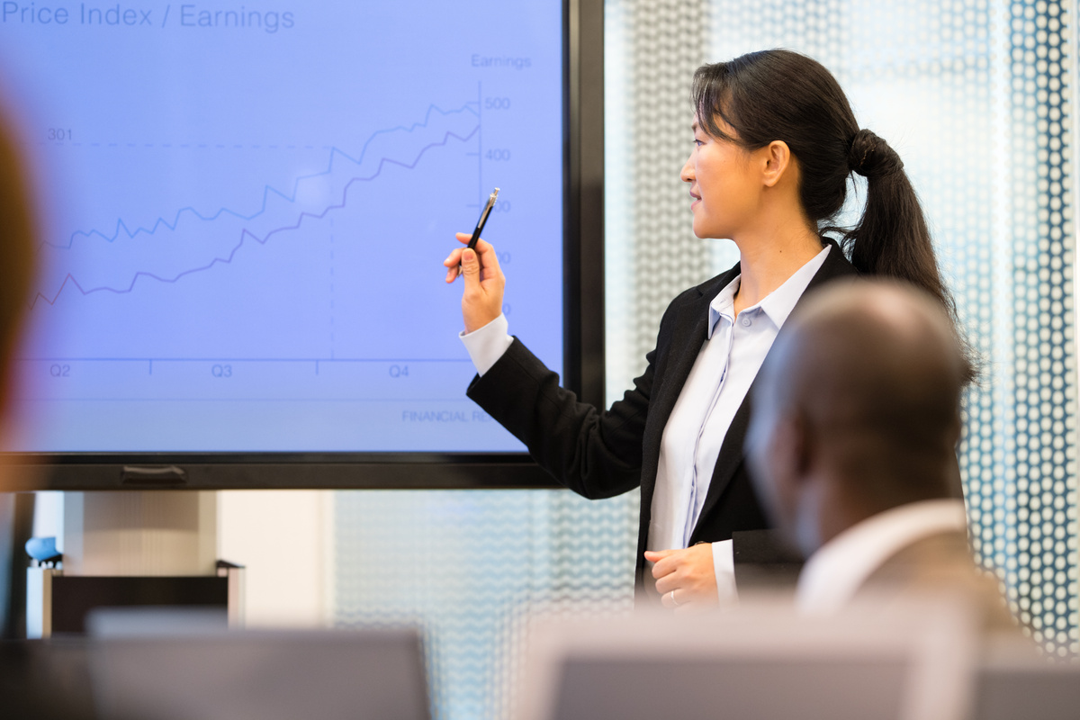 Businesswoman explaining graph to businessman